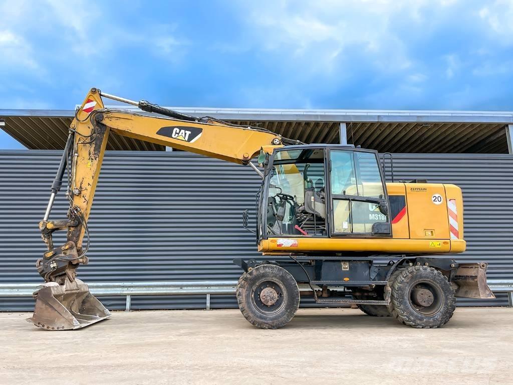 CAT M318F حفارات بعجل