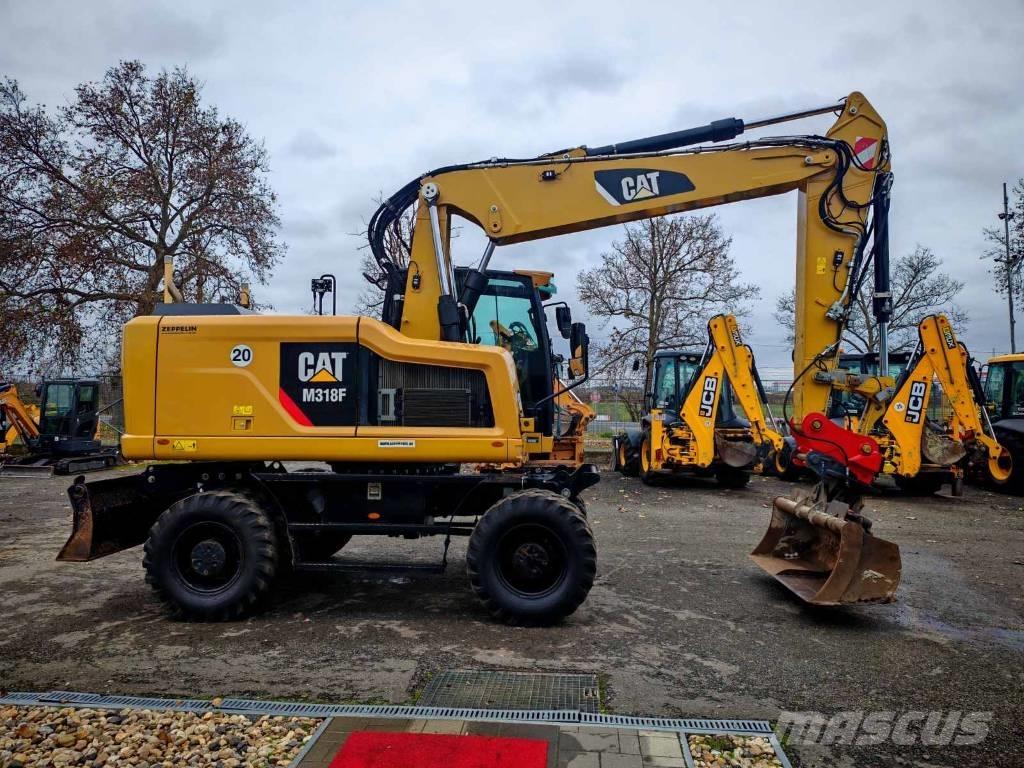 CAT M 318 F حفارات بعجل