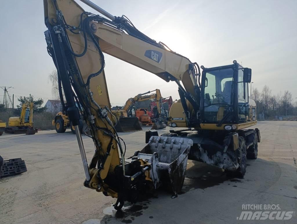 CAT M 313 D حفارات بعجل