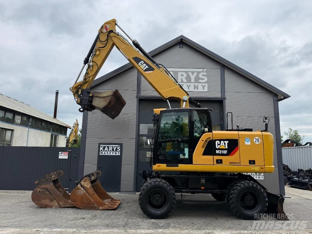 CAT M 318 F حفارات بعجل