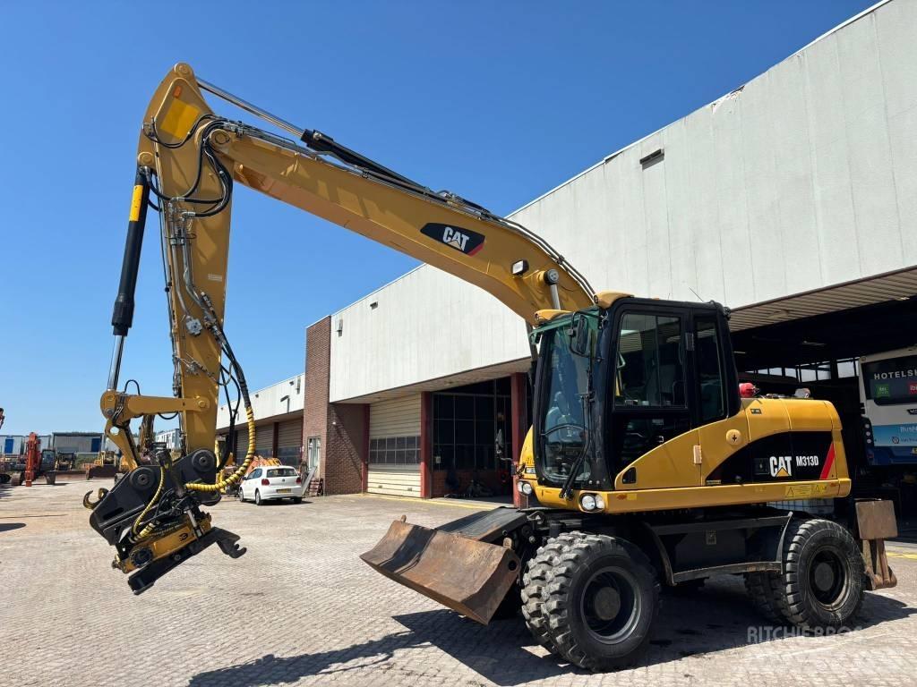CAT M 313 D حفارات بعجل