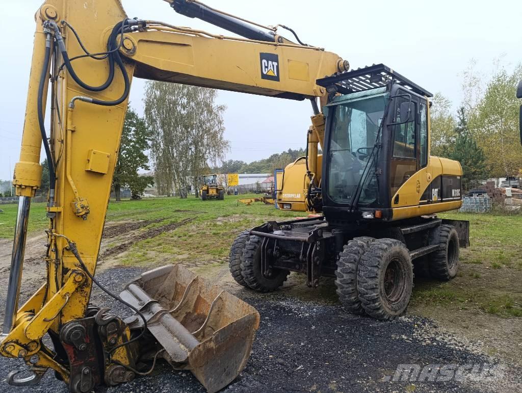 CAT M 318 C حفارات بعجل
