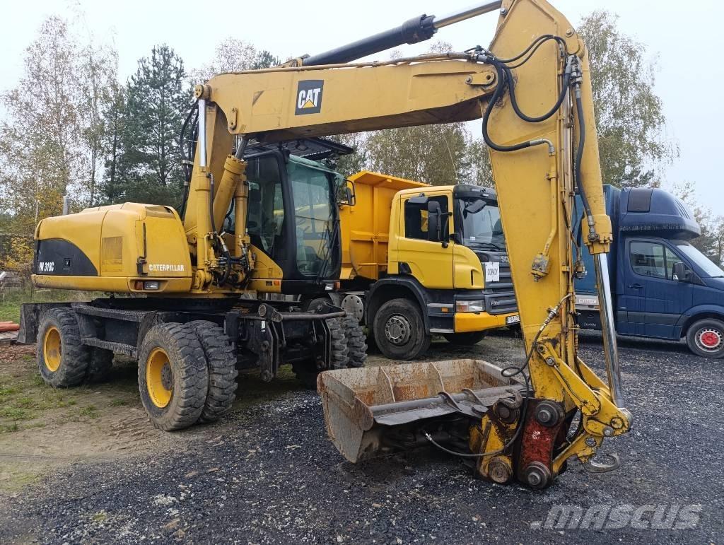 CAT M 318 C حفارات بعجل