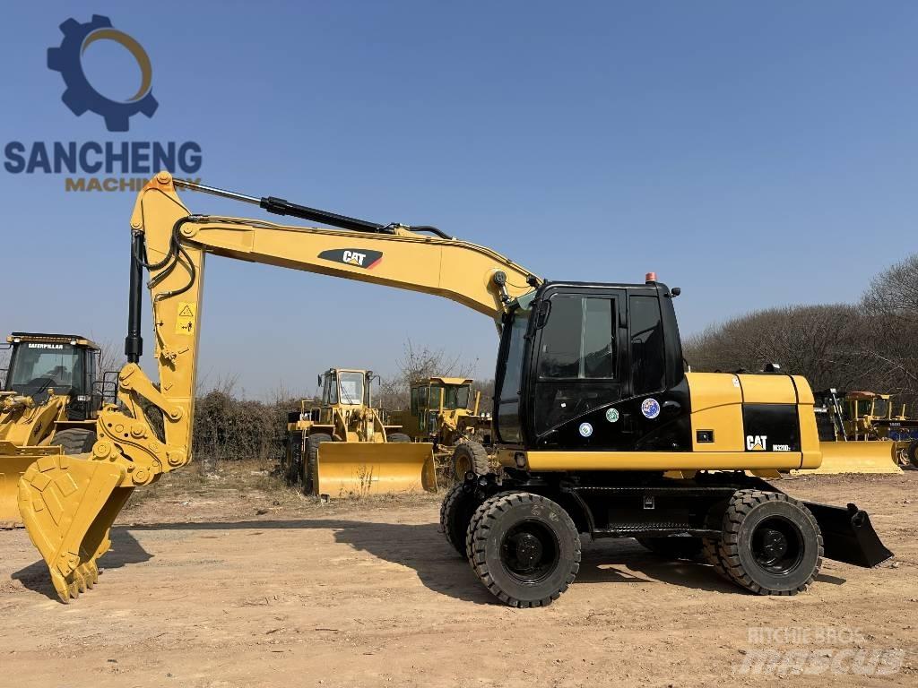 CAT M 320 D2 حفارات بعجل