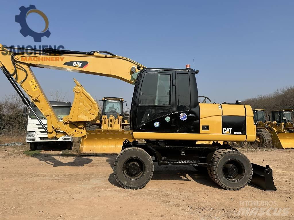 CAT M 320 D2 حفارات بعجل