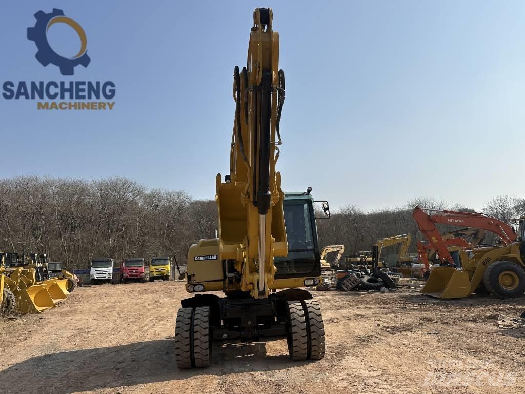 CAT M 320 D2 حفارات بعجل