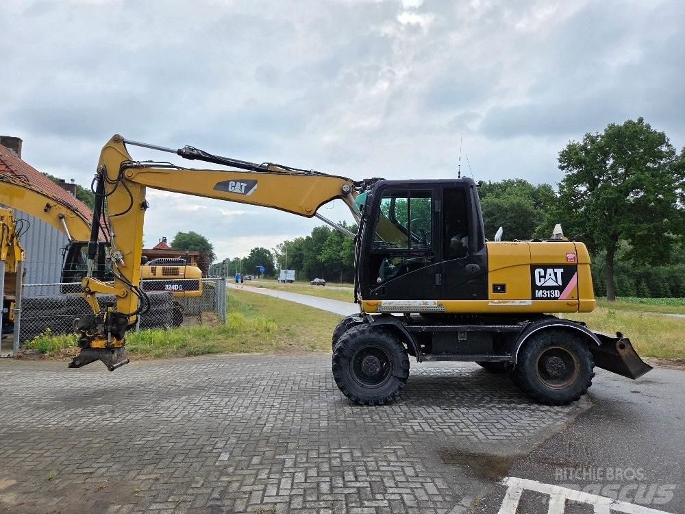 CAT M313D حفارات بعجل