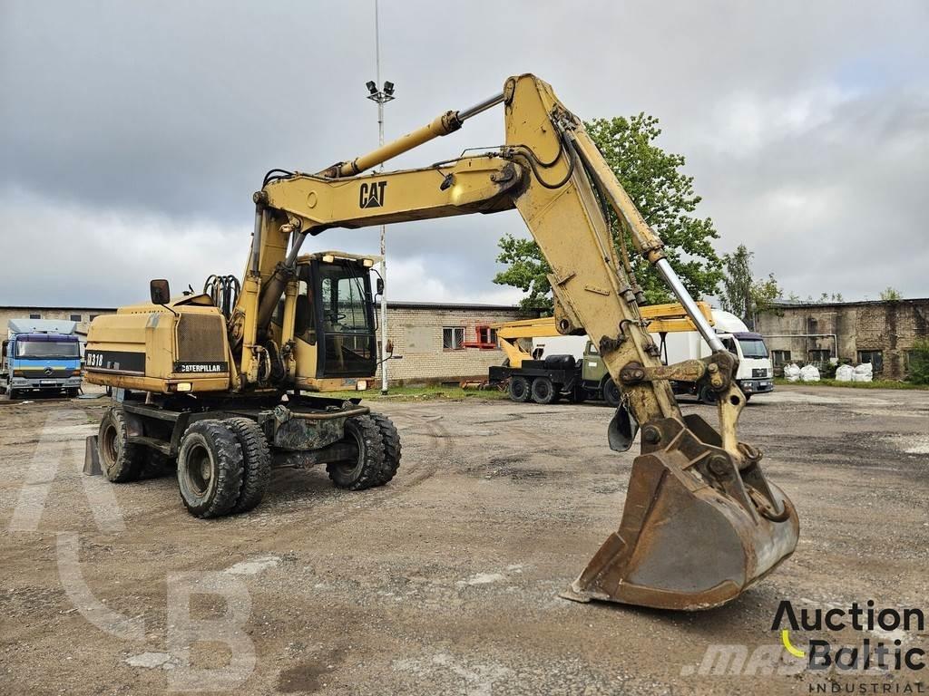 CAT M 318 C حفارات بعجل