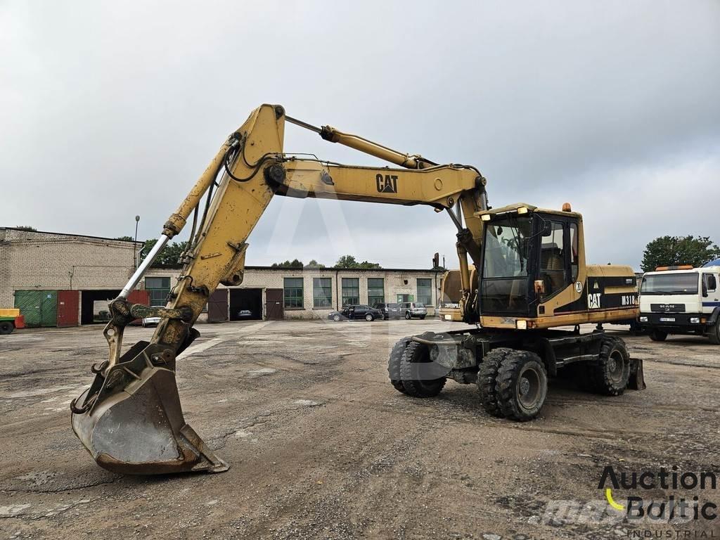 CAT M 318 C حفارات بعجل