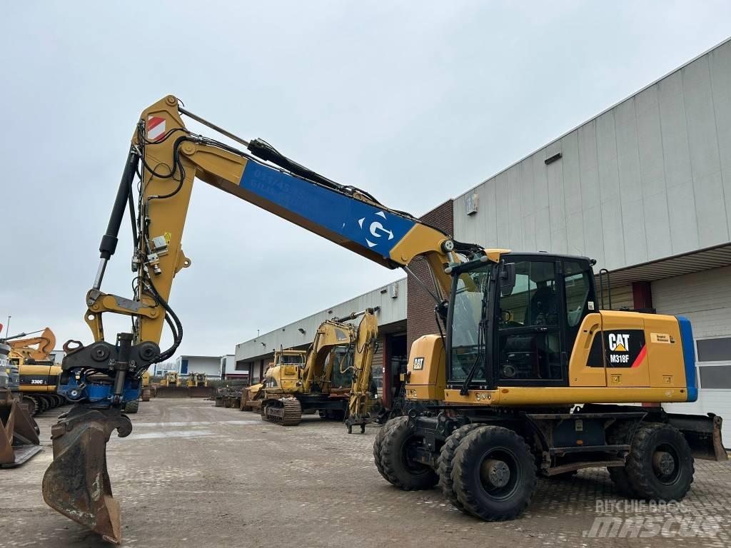CAT M 318 F حفارات بعجل