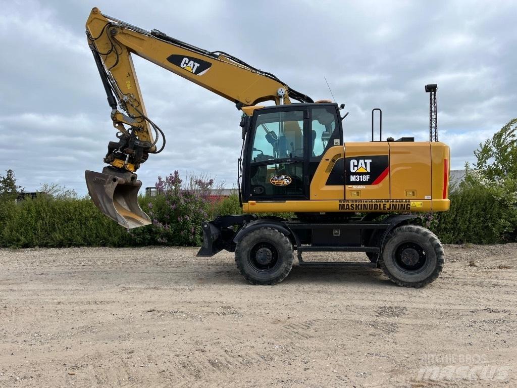 CAT M 318 F حفارات بعجل