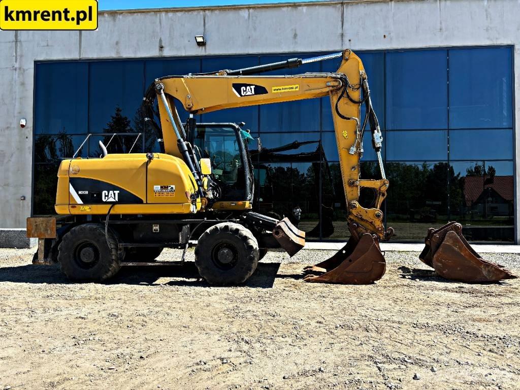 CAT M 313 D حفارات بعجل