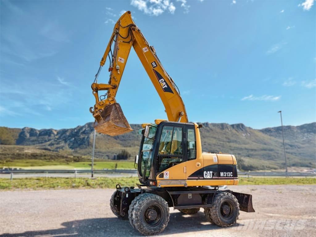 CAT M 313 C حفارات بعجل