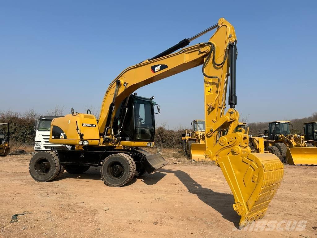 CAT M 320D حفارات بعجل