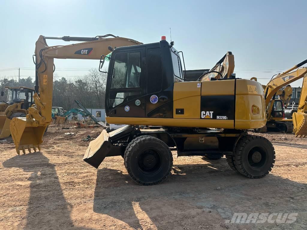 CAT M 320D حفارات بعجل