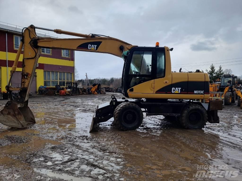 CAT M 313 C حفارات بعجل