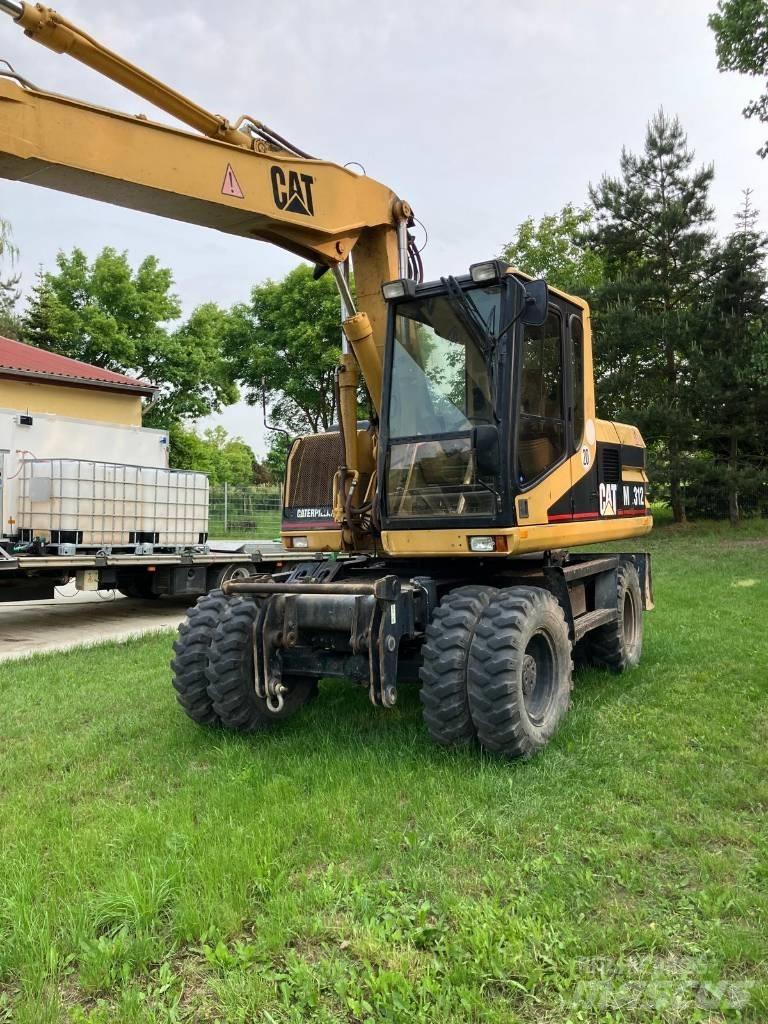 CAT M 312 حفارات بعجل