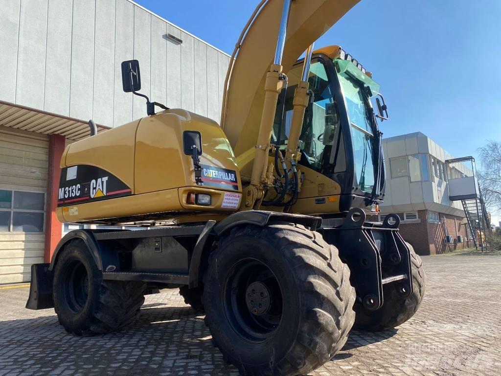 CAT M 313 C حفارات بعجل