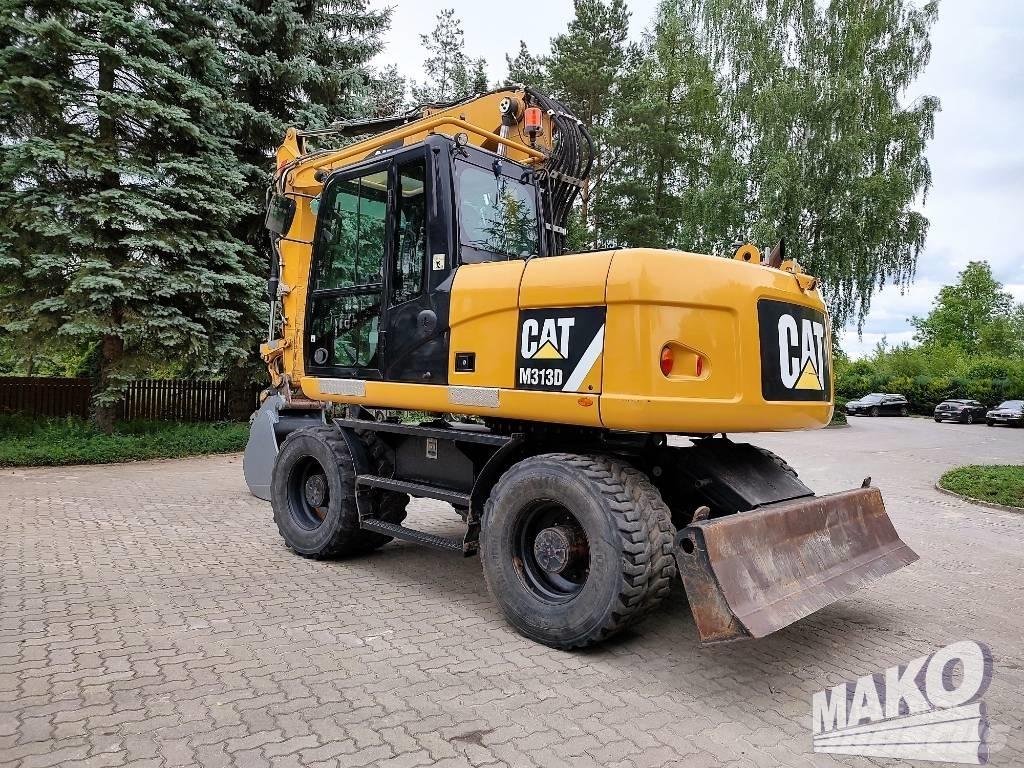 CAT M 313 D حفارات بعجل