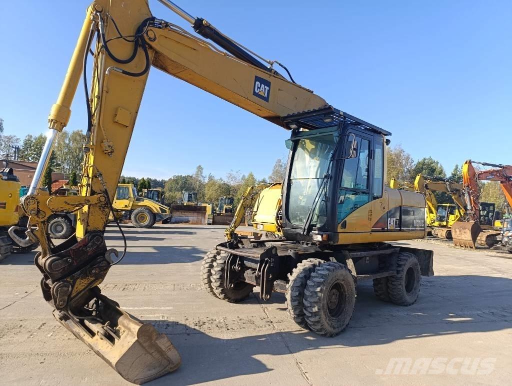 CAT M 318 C حفارات بعجل