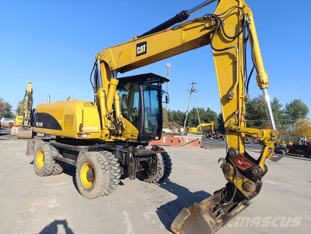 CAT M 318 C حفارات بعجل