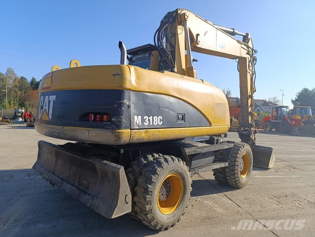 CAT M 318 C حفارات بعجل