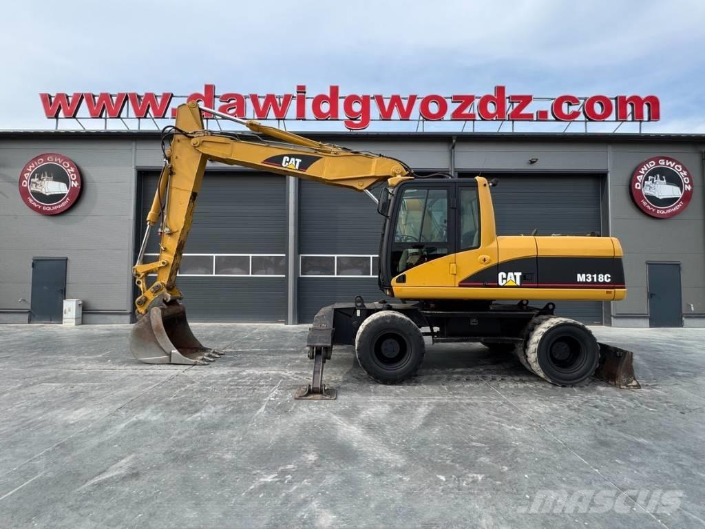 CAT M 318 C حفارات بعجل