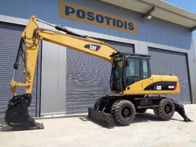 CAT M 318 D حفارات بعجل