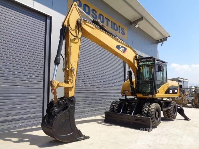 CAT M 318 D حفارات بعجل