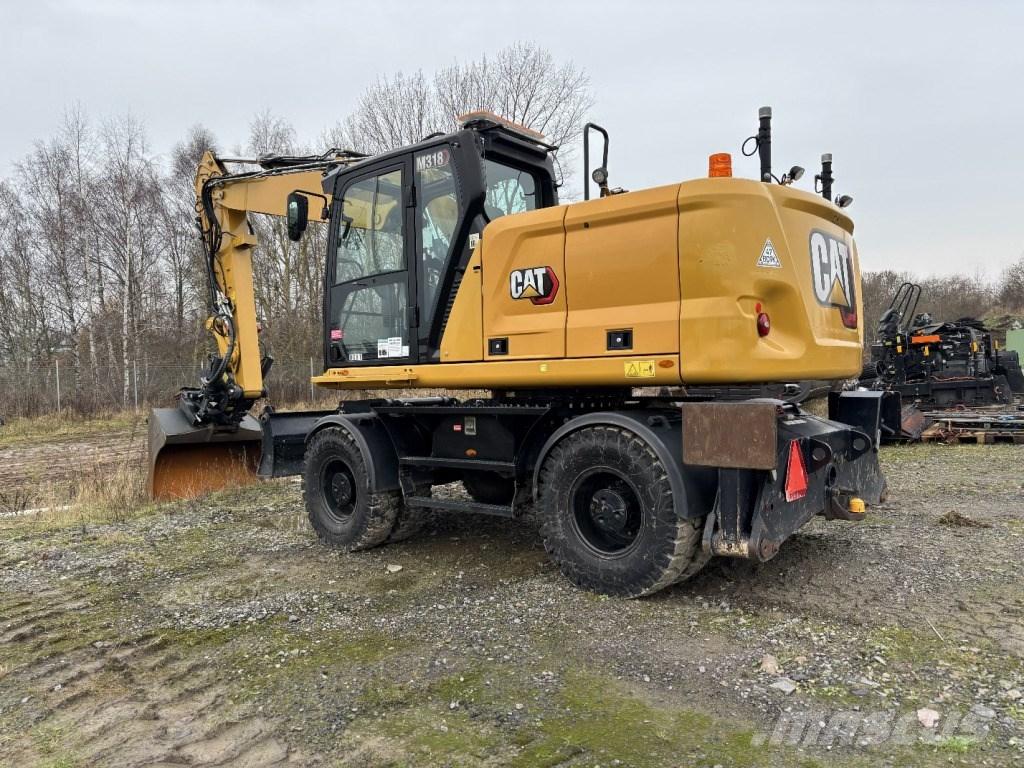 CAT M 318 حفارات بعجل