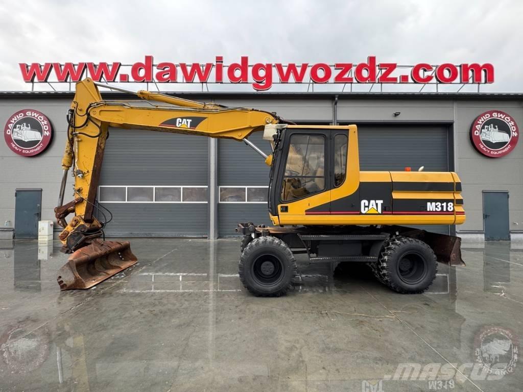 CAT M 318 حفارات بعجل