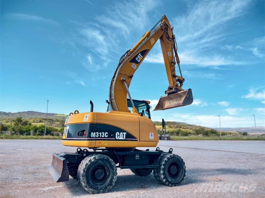 CAT M 313 C حفارات بعجل