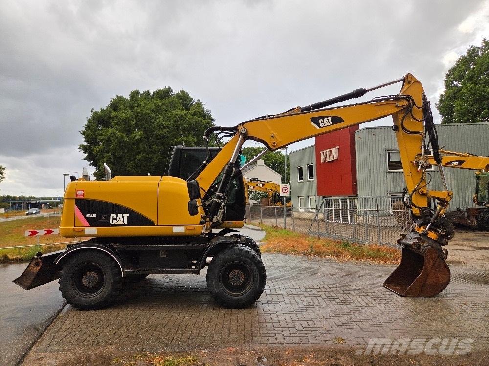 CAT M313D حفارات بعجل