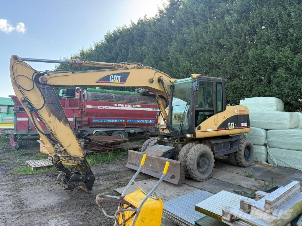 CAT M 313 C حفارات بعجل