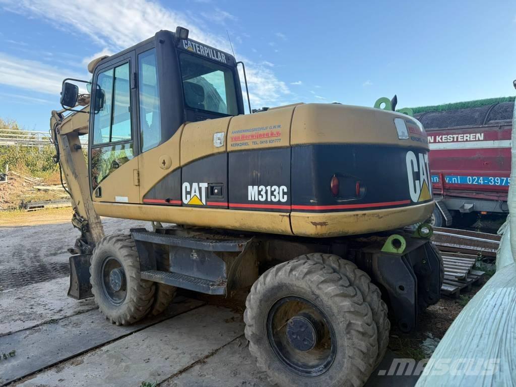 CAT M 313 C حفارات بعجل