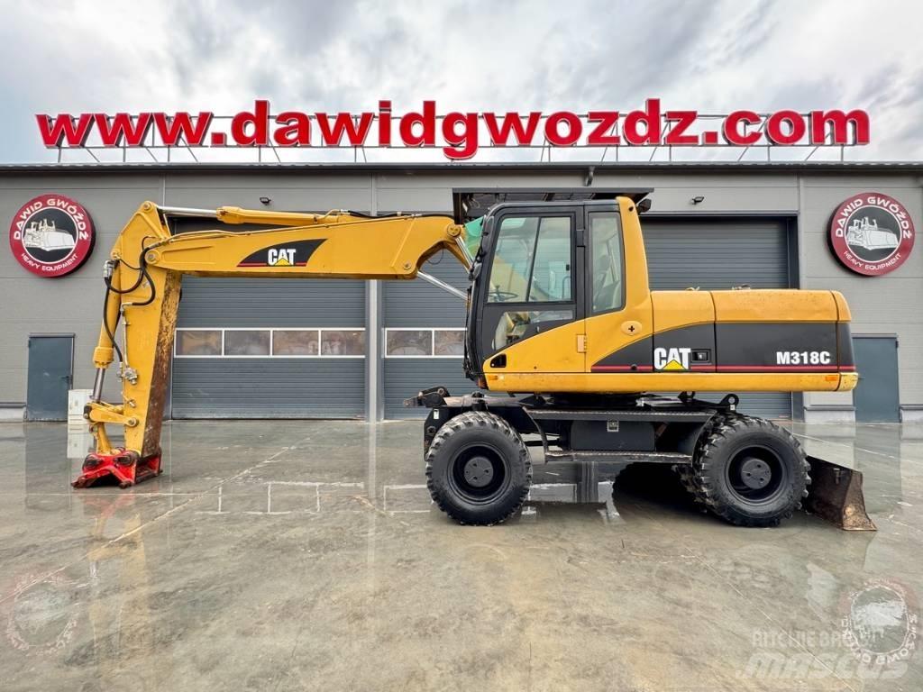 CAT M 318 C حفارات بعجل