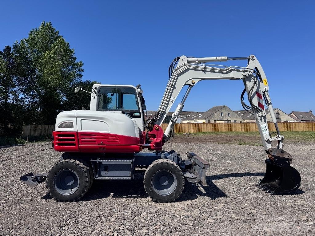 Takeuchi TB 295 W حفارات بعجل