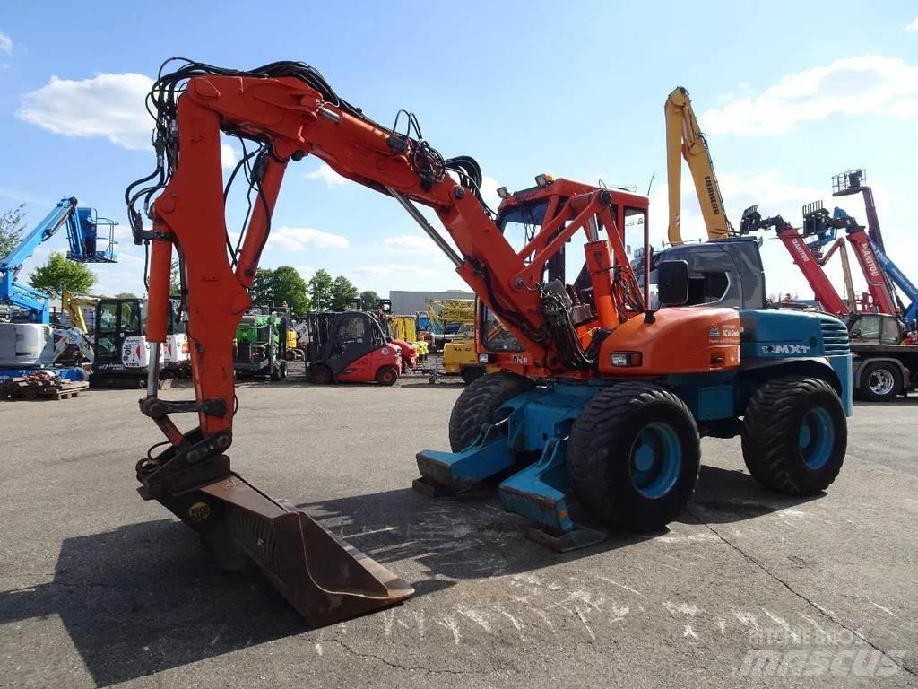 Mecalac 12MXT حفارات بعجل