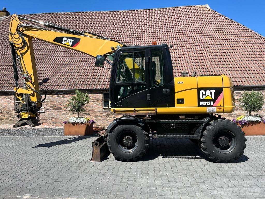 CAT M 313 D حفارات بعجل