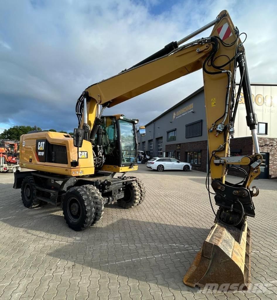 CAT M 318 F حفارات بعجل
