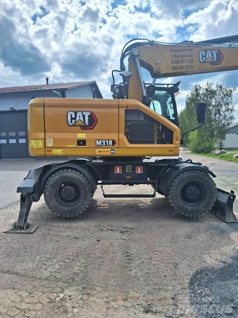 CAT M 318 حفارات بعجل