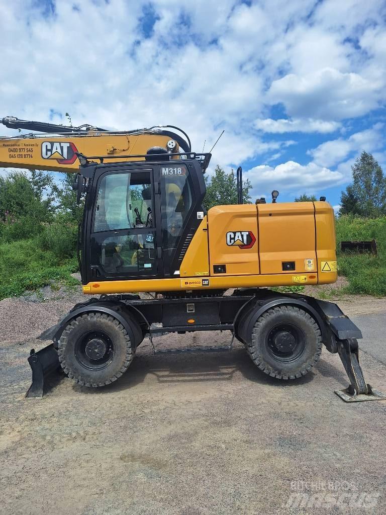 CAT M 318 حفارات بعجل