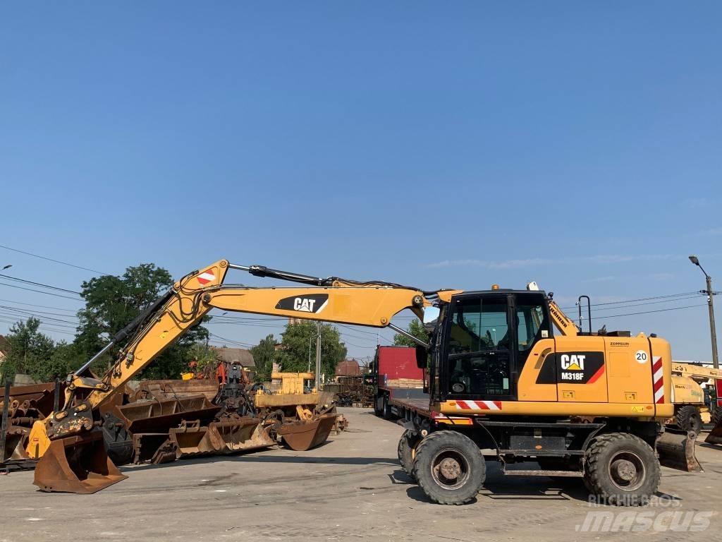CAT M 318 F حفارات بعجل