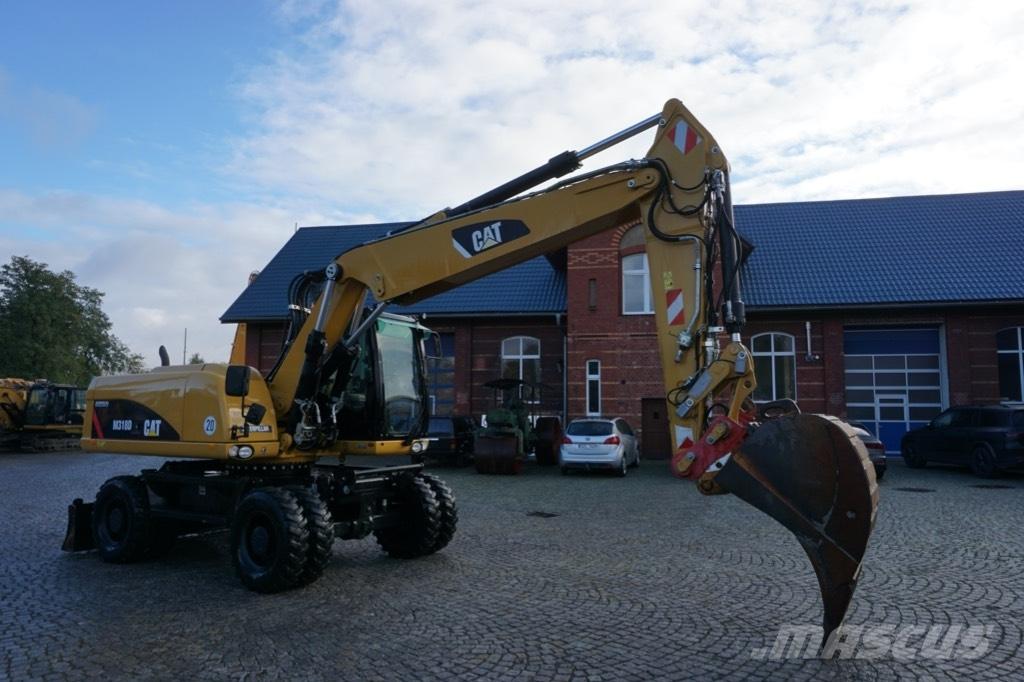 CAT M 318 D حفارات بعجل