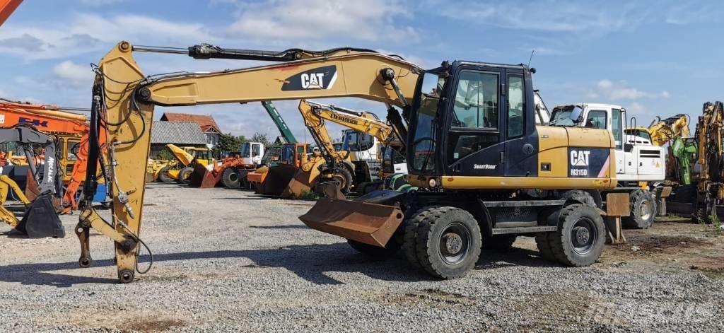 CAT M 315 D حفارات بعجل