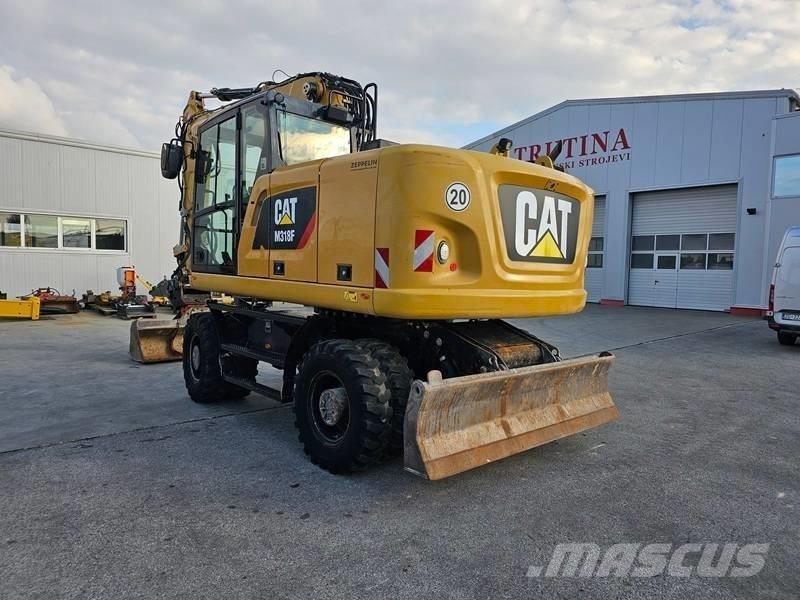 CAT M 318 F حفارات بعجل