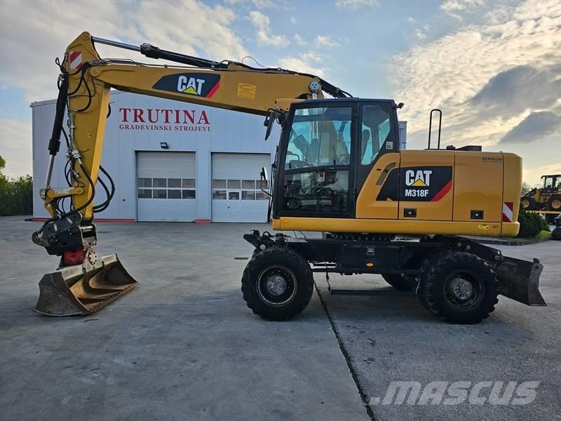 CAT M 318 F حفارات بعجل