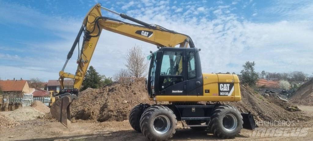 CAT M 313 D حفارات بعجل