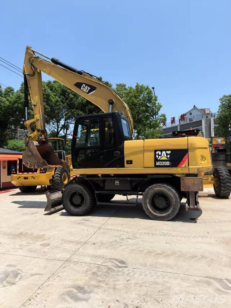 CAT M 320 حفارات بعجل