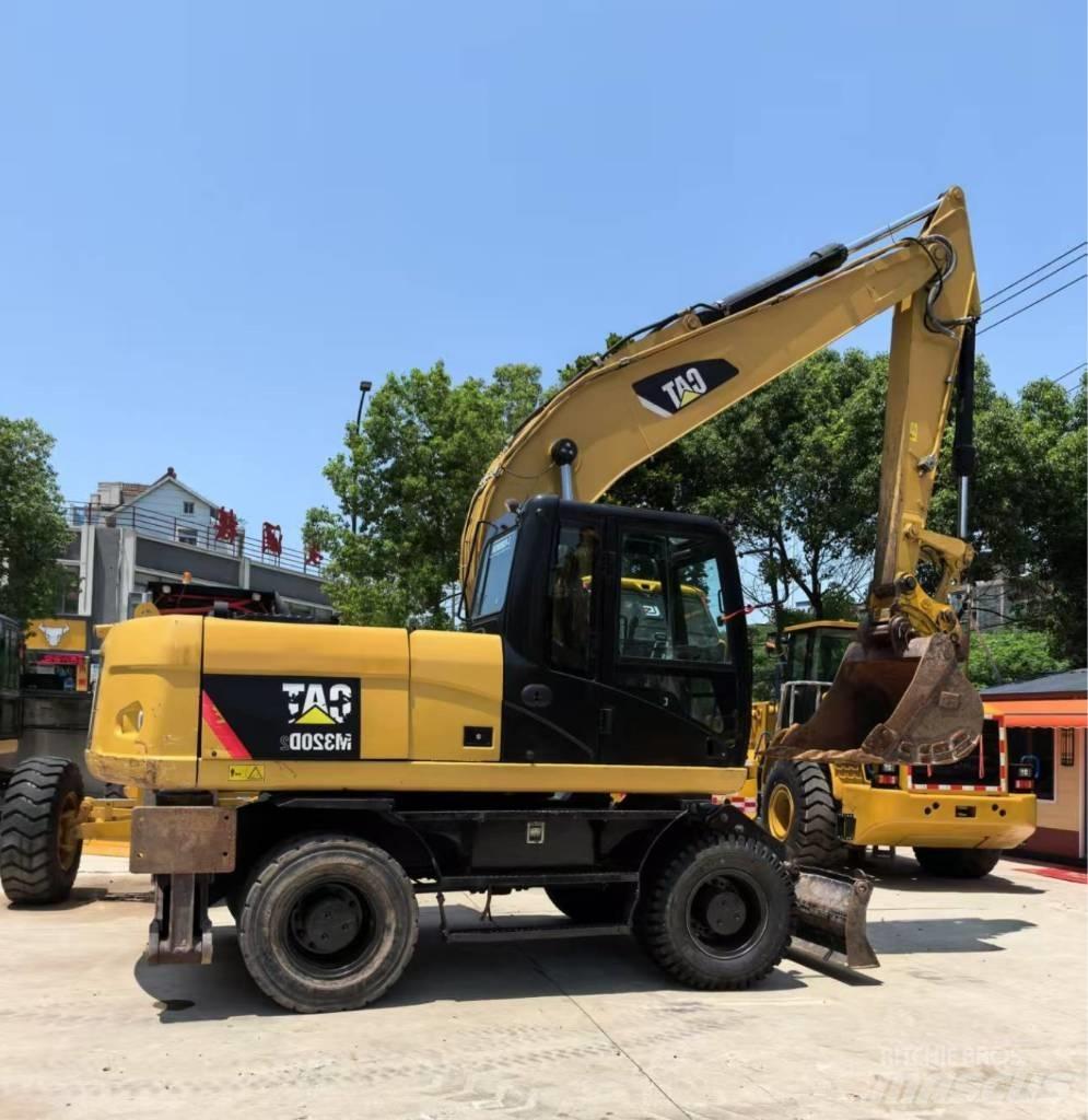 CAT M 320 حفارات بعجل